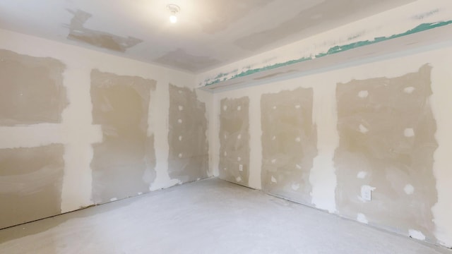 1 Barker St, Jay, ME 04239 - empty room with unfinished concrete floors