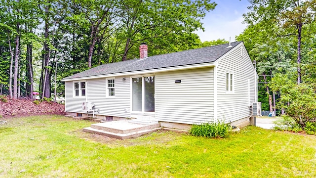 1 Barker St, Jay, ME 04239 - rear view of property featuring a lawn, a chimney, and a shingled roof