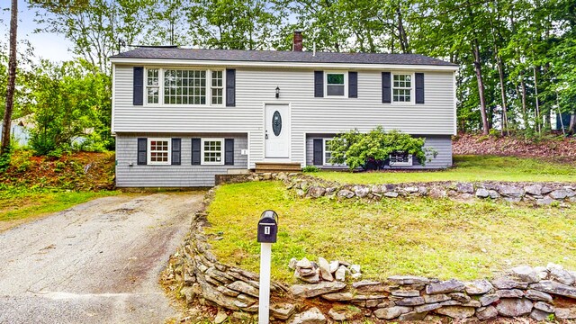 1 Barker St, Jay, ME 04239 - bi-level home featuring a chimney, a front lawn, and entry steps
