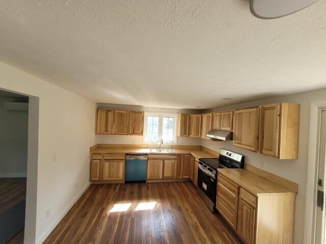 1 Barker St, Jay, ME 04239 - kitchen with stainless steel electric range, dishwashing machine, under cabinet range hood, dark wood-style floors, and a textured ceiling