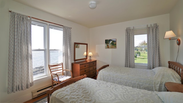 65 Shell Rd, Phippsburg, ME 04562 - bedroom featuring multiple windows, wood finished floors, and a water view