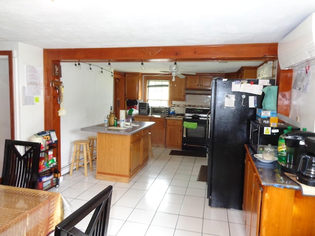 27 Grove St, Sanford, ME 04083 - kitchen with black appliances, brown cabinets, a ceiling fan, under cabinet range hood, and beamed ceiling