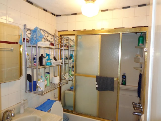 27 Grove St, Sanford, ME 04083 - bathroom featuring a shower with shower door, decorative backsplash, and tile walls