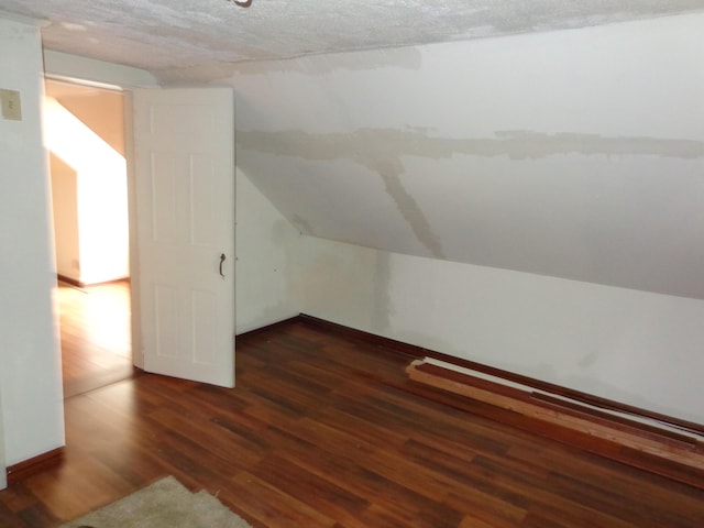 27 Grove St, Sanford, ME 04083 - additional living space with wood finished floors, lofted ceiling, and a textured ceiling
