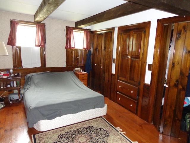 27 Grove St, Sanford, ME 04083 - bedroom featuring beamed ceiling, wood finished floors, and two closets
