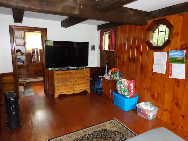27 Grove St, Sanford, ME 04083 - living room featuring beam ceiling, wood finished floors, wooden walls, and a baseboard radiator