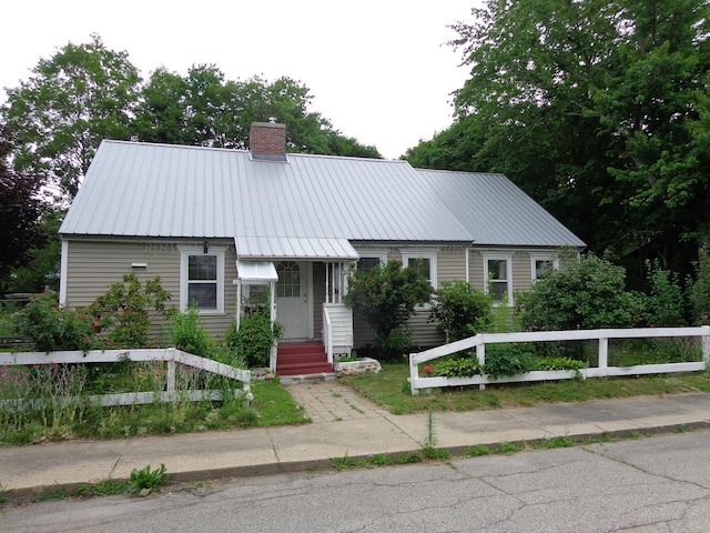 27 Grove St, Sanford, ME 04083 - view of front of property with a chimney and a metal roof