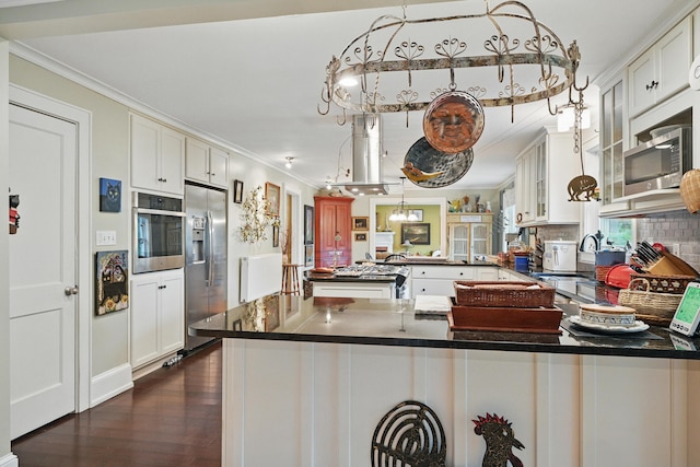 4 Mayflower Rd, Hallowell, ME 04347 - kitchen featuring stainless steel appliances, ornamental molding, a peninsula, dark wood finished floors, and glass insert cabinets