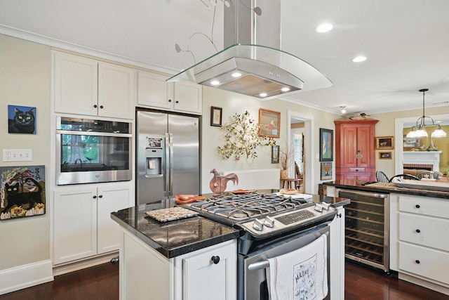 4 Mayflower Rd, Hallowell, ME 04347 - kitchen featuring appliances with stainless steel finishes, wine cooler, island range hood, dark countertops, and white cabinetry