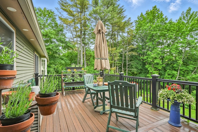 4 Mayflower Rd, Hallowell, ME 04347 - wooden deck featuring view of scattered trees and outdoor dining area