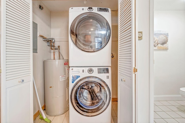 3 Ocean Breeze Unit 2, York, ME 03909 - laundry room with water heater, stacked washer / dryer, light tile patterned floors, and baseboards