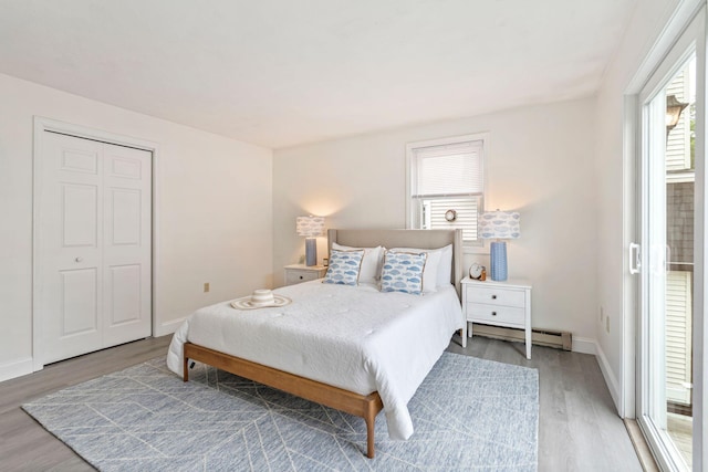 3 Ocean Breeze Unit 2, York, ME 03909 - bedroom featuring wood finished floors, multiple windows, a baseboard radiator, and baseboards