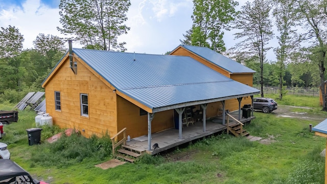 54 Carver Rd, Milo, ME 04463 - view of side of property with metal roof and a yard