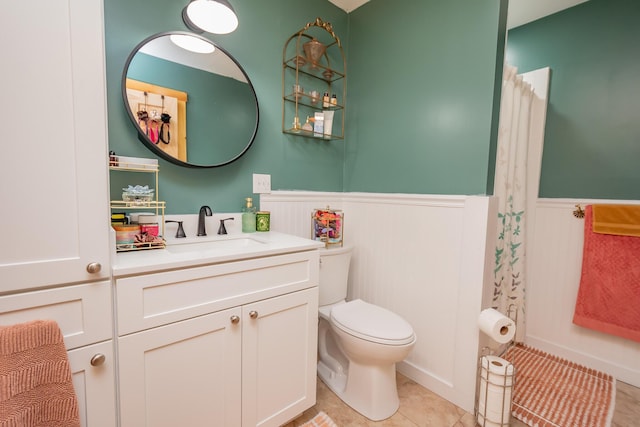 54 Carver Rd, Milo, ME 04463 - full bath with wainscoting, toilet, vanity, a shower with shower curtain, and tile patterned flooring