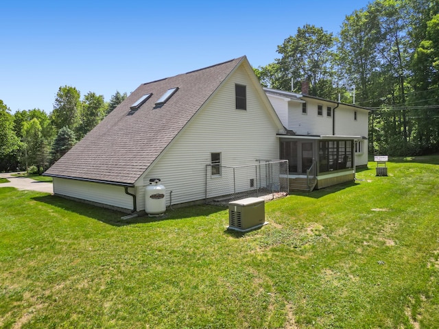 426 Fuller Rd, Carmel, ME 04419 - view of property exterior featuring a sunroom, a chimney, a lawn, and a shingled roof