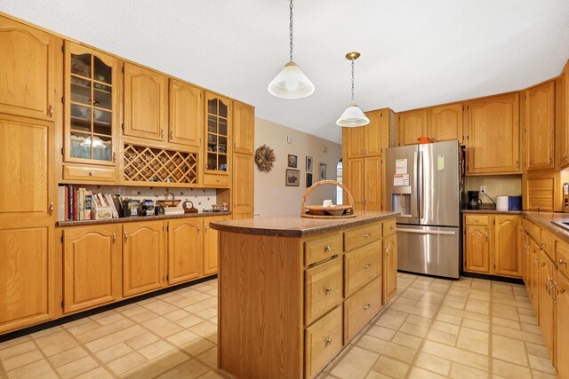 426 Fuller Rd, Carmel, ME 04419 - kitchen with stainless steel fridge with ice dispenser, a center island, pendant lighting, glass insert cabinets, and dark countertops