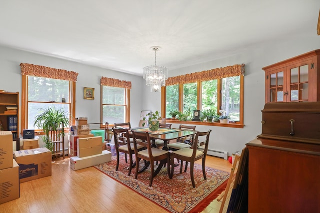 426 Fuller Rd, Carmel, ME 04419 - dining space featuring a chandelier, baseboard heating, and light wood finished floors