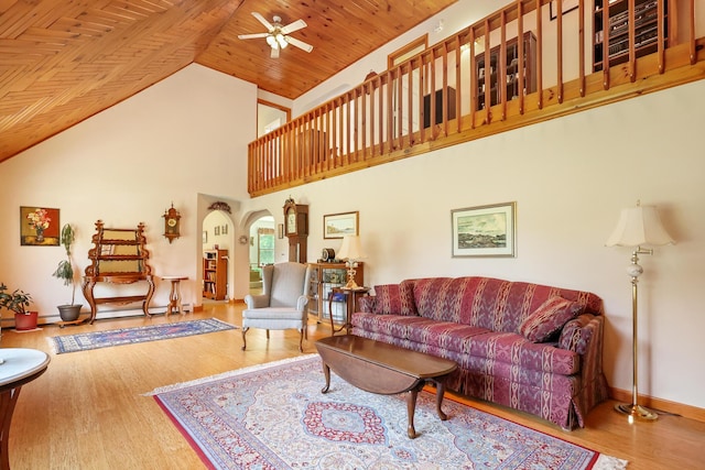 426 Fuller Rd, Carmel, ME 04419 - living room featuring arched walkways, a ceiling fan, wood finished floors, high vaulted ceiling, and wooden ceiling