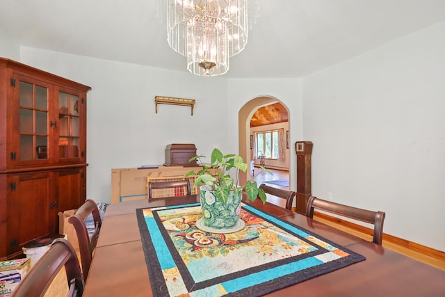 426 Fuller Rd, Carmel, ME 04419 - dining area with arched walkways, a chandelier, and wood finished floors