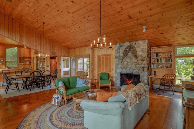 47 Eaton Point Rd, Deer Isle, ME 04627 - living room featuring lofted ceiling, wood-type flooring, a chandelier, a fireplace, and wood walls
