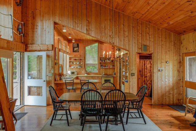 47 Eaton Point Rd, Deer Isle, ME 04627 - dining room with wood walls, wood-type flooring, a towering ceiling, wooden ceiling, and a chandelier