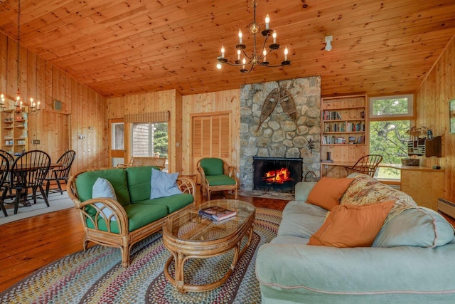 47 Eaton Point Rd, Deer Isle, ME 04627 - living room featuring a chandelier, hardwood / wood-style floors, wooden ceiling, wooden walls, and a fireplace