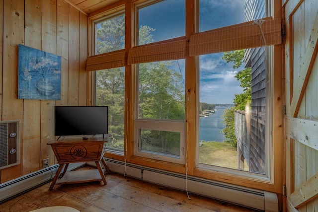 47 Eaton Point Rd, Deer Isle, ME 04627 - entryway with a baseboard radiator, wood walls, and hardwood / wood-style flooring