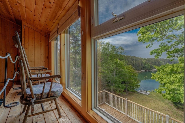 47 Eaton Point Rd, Deer Isle, ME 04627 - sunroom / solarium with a water view, vaulted ceiling, a view of trees, wooden walls, and healthy amount of natural light