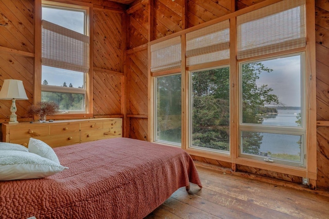 47 Eaton Point Rd, Deer Isle, ME 04627 - bedroom featuring wood walls, hardwood / wood-style floors, multiple windows, and a towering ceiling