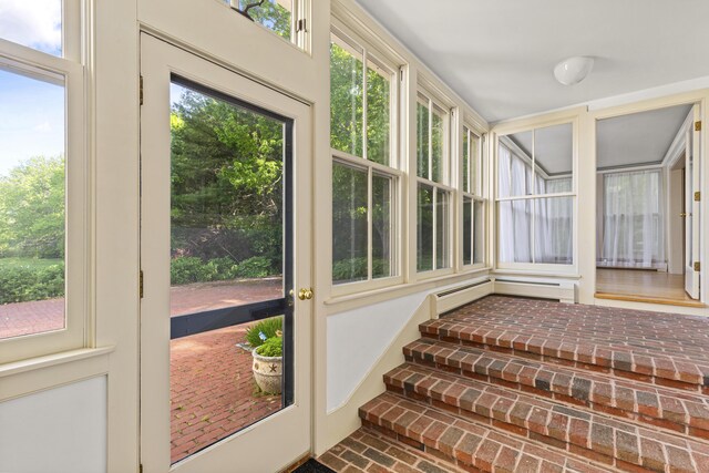 565 Bagaduce Rd, Brooksville, ME 04617 - unfurnished sunroom featuring brick flooring and a baseboard heating unit