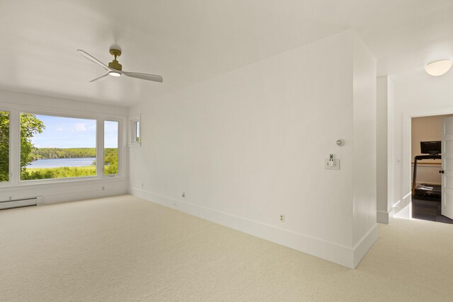 565 Bagaduce Rd, Brooksville, ME 04617 - carpeted spare room featuring ceiling fan, baseboards, and a baseboard heating unit