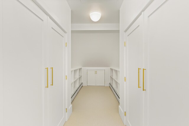 565 Bagaduce Rd, Brooksville, ME 04617 - hallway featuring a baseboard radiator and light colored carpet