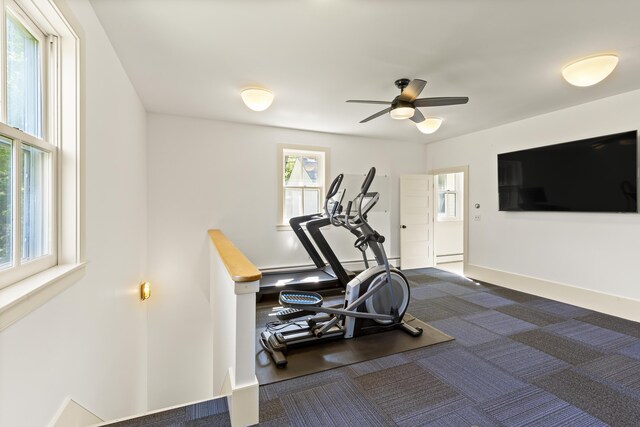 565 Bagaduce Rd, Brooksville, ME 04617 - workout area featuring a ceiling fan, dark carpet, and baseboards