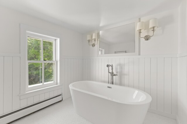 565 Bagaduce Rd, Brooksville, ME 04617 - bathroom with a baseboard heating unit, wainscoting, and a freestanding bath