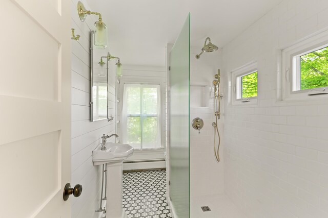 565 Bagaduce Rd, Brooksville, ME 04617 - bathroom with a tile shower, baseboard heating, and a sink