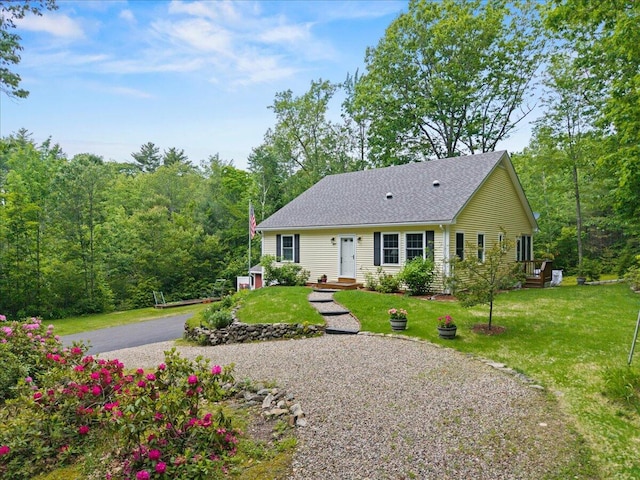 489 Shady Nook Rd, Newfield, ME 04095 - view of front of property with a front lawn, roof with shingles, and a view of trees