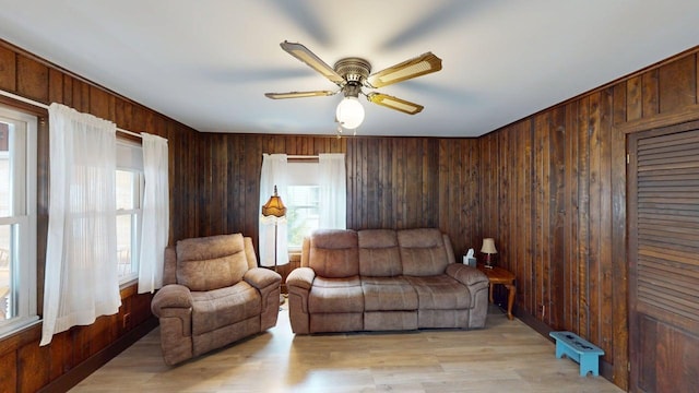 180 Bowdoin St, Millinocket, ME 04462 - living area featuring wooden walls, a ceiling fan, and light wood-style flooring