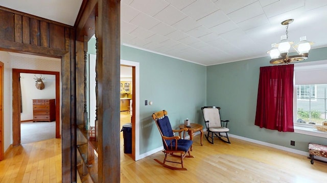 180 Bowdoin St, Millinocket, ME 04462 - sitting room featuring light wood-type flooring, a chandelier, crown molding, and baseboards