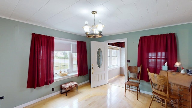 180 Bowdoin St, Millinocket, ME 04462 - entrance foyer featuring a chandelier, wood finished floors, crown molding, and baseboards