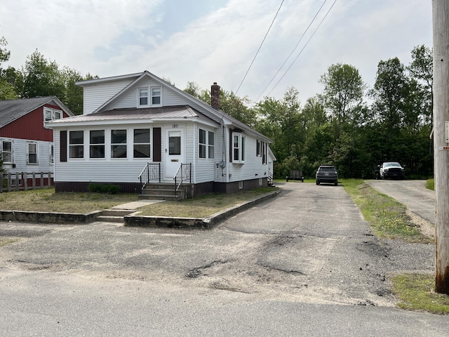180 Bowdoin St, Millinocket, ME 04462 - view of front of home featuring asphalt driveway and metal roof