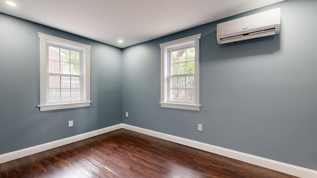 422 Centre St, Bath, ME 04530 - empty room with a wall unit AC, plenty of natural light, dark wood finished floors, and recessed lighting