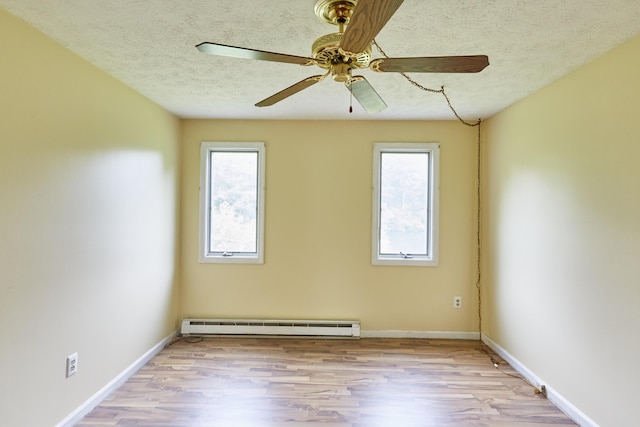 1372 Post Rd Unit 3A, Wells, ME 04090 - unfurnished room with a baseboard radiator, wood finished floors, ceiling fan, a textured ceiling, and baseboards