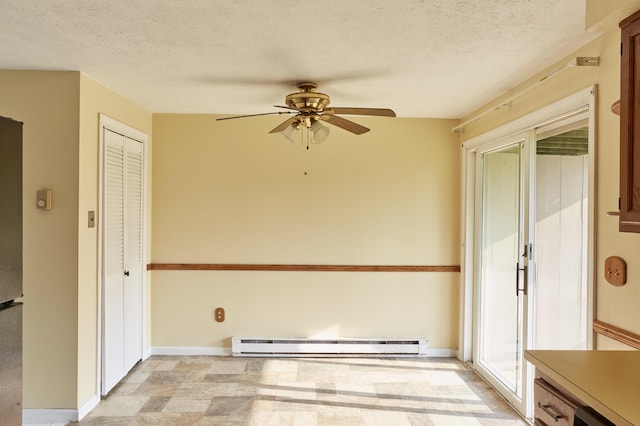 1372 Post Rd Unit 3A, Wells, ME 04090 - unfurnished dining area featuring baseboard heating, a ceiling fan, a textured ceiling, and baseboards