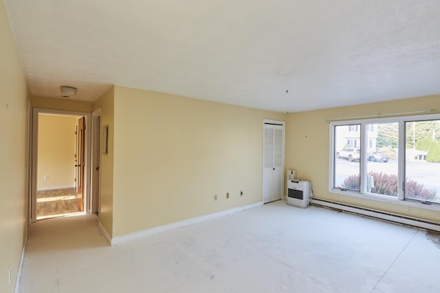 1372 Post Rd Unit 3A, Wells, ME 04090 - unfurnished room featuring a baseboard heating unit and baseboards