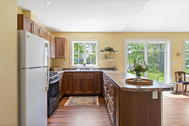189 Basin Point Rd, Harpswell, ME 04079 - kitchen with freestanding refrigerator, stainless steel gas stove, a peninsula, plenty of natural light, and recessed lighting