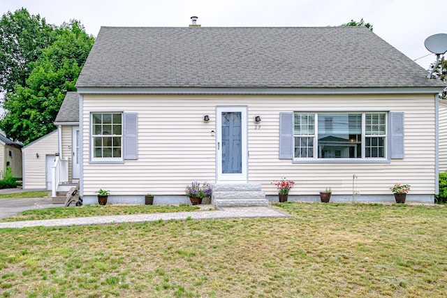 29 Harding St, Biddeford, ME 04005 - view of front of home featuring a front yard, entry steps, roof with shingles, and an outbuilding