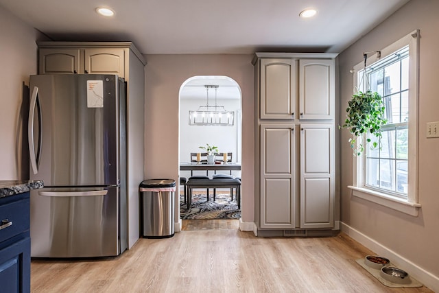 29 Harding St, Biddeford, ME 04005 - kitchen with freestanding refrigerator, light wood-type flooring, recessed lighting, arched walkways, and baseboards
