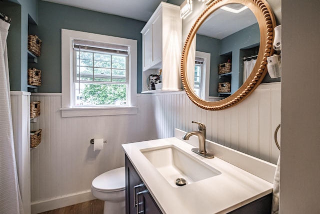 29 Harding St, Biddeford, ME 04005 - full bathroom featuring wainscoting, toilet, vanity, wood finished floors, and curtained shower