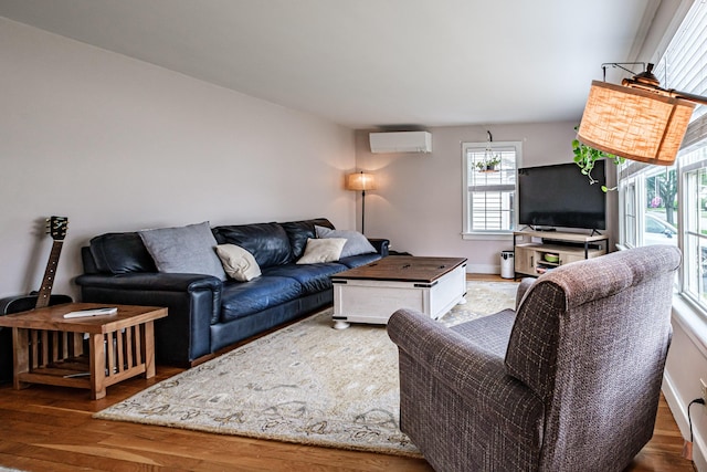 29 Harding St, Biddeford, ME 04005 - living room with a wall unit AC and wood finished floors