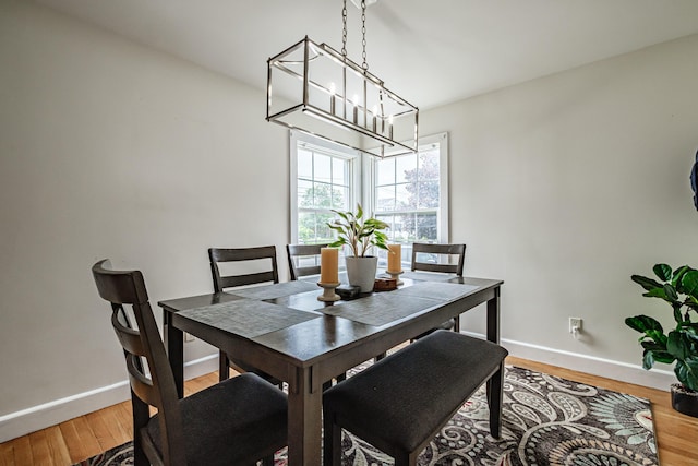 29 Harding St, Biddeford, ME 04005 - dining space featuring a chandelier, baseboards, and light wood finished floors